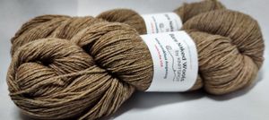Two hanks of a wool-alpaca blend yarn, in the fiber's natural warm brown color.
